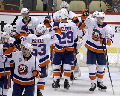 New York Islanders celebrate at the end of Game 4 of an NHL hockey first-round playoff series against the Pittsburgh Penguins in Pittsburgh, Tuesday, April 16, 2019. The Islanders won 3-1, and swept the series. (Gene J. Puskar / Associated Press)