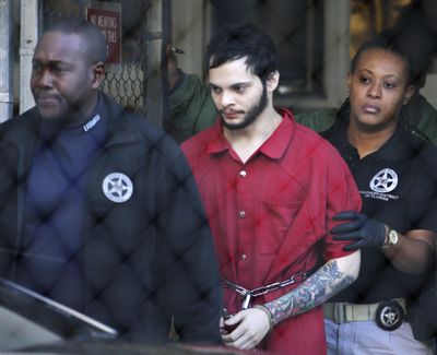 Esteban Santiago, center, is led from the Broward County jail for an arraignment in federal court Jan. 30, 2017, in Fort Lauderdale, Fla.Santiago, a 28-year-old Alaska man, pled guilty in the January 2017 Florida airport shooting that left five people dead and six wounded. (Lynne Sladky / Associated Press)