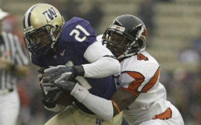 
Oregon State cornerback Francies Coye, right, brings down Washington wide receiver Sonny Shackelford during the second quarter Saturday in Seattle. 
 (Associated Press / The Spokesman-Review)