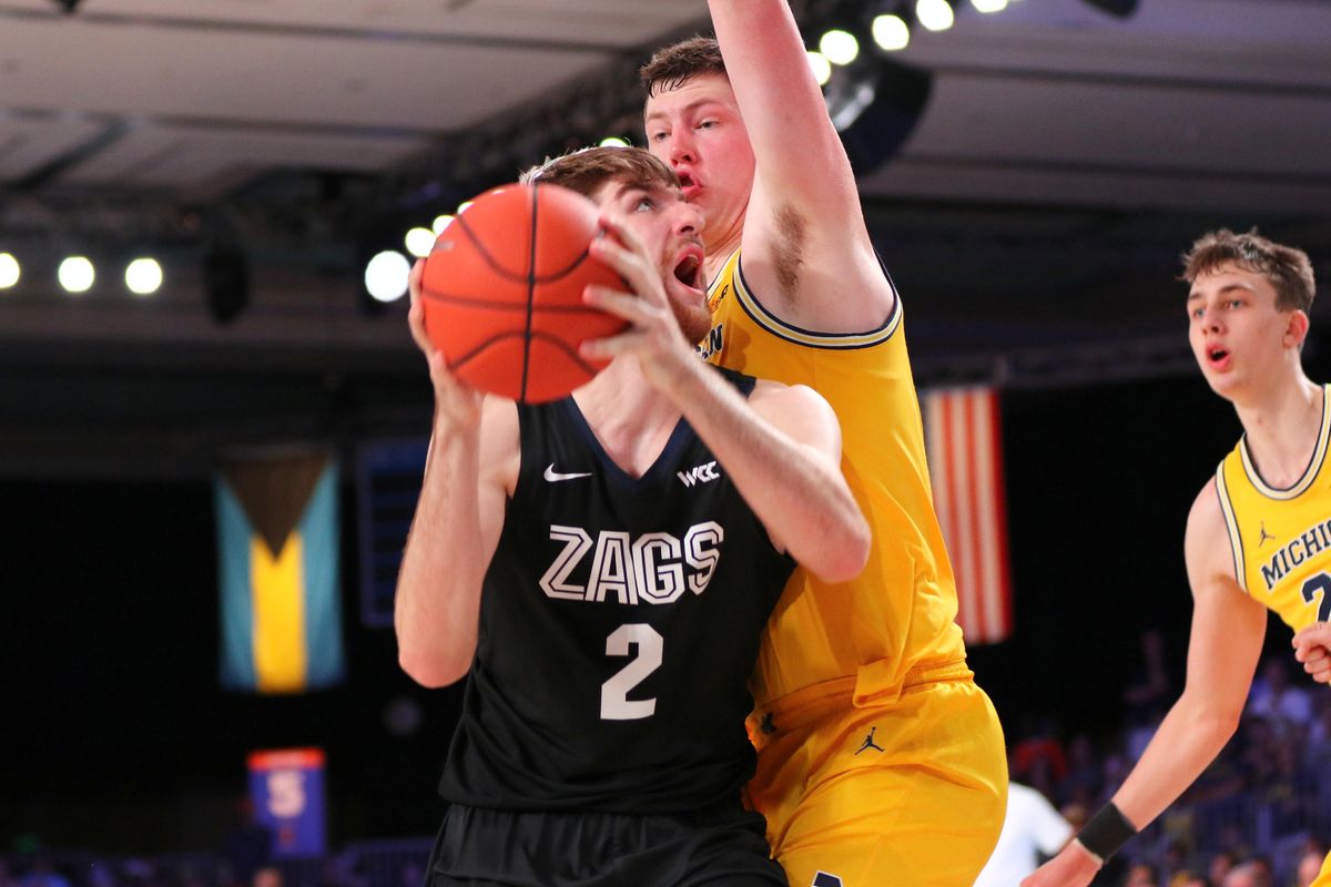Gonzaga forward Drew Timme, left, is smothered by a Michigan defender during the Battle 4 Atlantis championship game on Friday, Nov. 29, 2019, in Paradise Island, Bahamas. (Torrey Vail / For The Spokesman-Review)