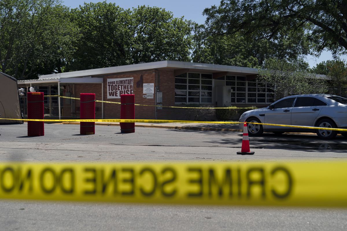 Crime scene tape surrounds Robb Elementary School in Uvalde, Texas, Wednesday, May 25, 2022. Desperation turned to heart-wrenching sorrow for families of grade schoolers killed after an 18-year-old gunman barricaded himself in their Texas classroom and began shooting, killing at least 19 fourth-graders and their two teachers.  (Jae C. Hong)