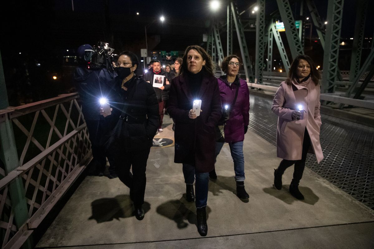 In a photo provided by Multnomah County, Multnomah County Chair Deborah Kafoury, center, leads the illuminated walk over the Hawthorne Bridge with Commissioners Lori Stegmann, left, Jessica Vega Pederson, second from right, and Susheela Jayapal, right, Thursday, March 10, 2022, in Portland, Ore., during an event held two years after the first confirmed case of COVID-19 in Portland.  (Motoya Nakamura)