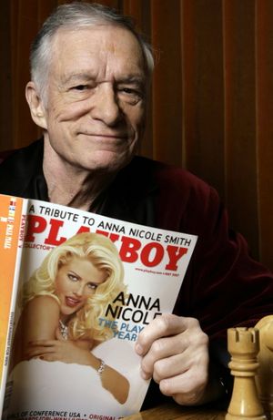 In this April 5, 2007, file photo, Playboy Enterprises founder Hugh Hefner poses with a copy of Playboy magazine featuring Anna Nicole Smith as Playmate of the Year, at the Playboy Mansion in Los Angeles. The magazine that helped usher in the sexual revolution in the 1950s and '60s by bringing nudity into America's living rooms announced this week that it will no longer run photos of completely naked women. Starting in March, 2016, Playboy's print edition will still feature women in provocative poses, but they will no longer be fully nude. (AP Photo/Damian Dovarganes, File)