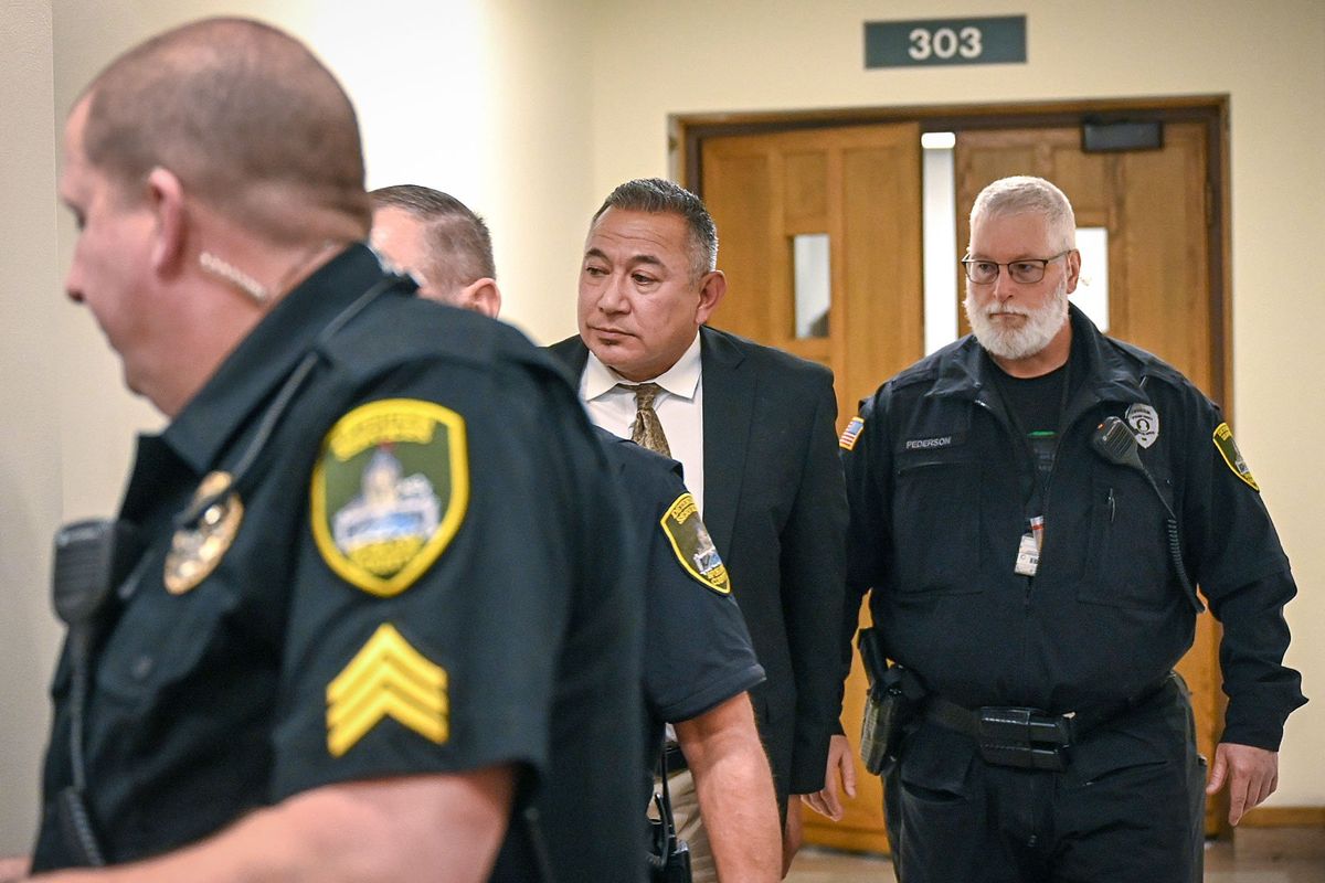 Richard Aguirre, 59, center, is led from court after being convicted, Tuesday, Dec. 26, 2023, for the 1986 killing of Ruby Doss, 27. Judge Jeremey Schmidt ruled Aguirre guilt of first-degree murder.  (DAN PELLE/THE SPOKESMAN-REVIEW)
