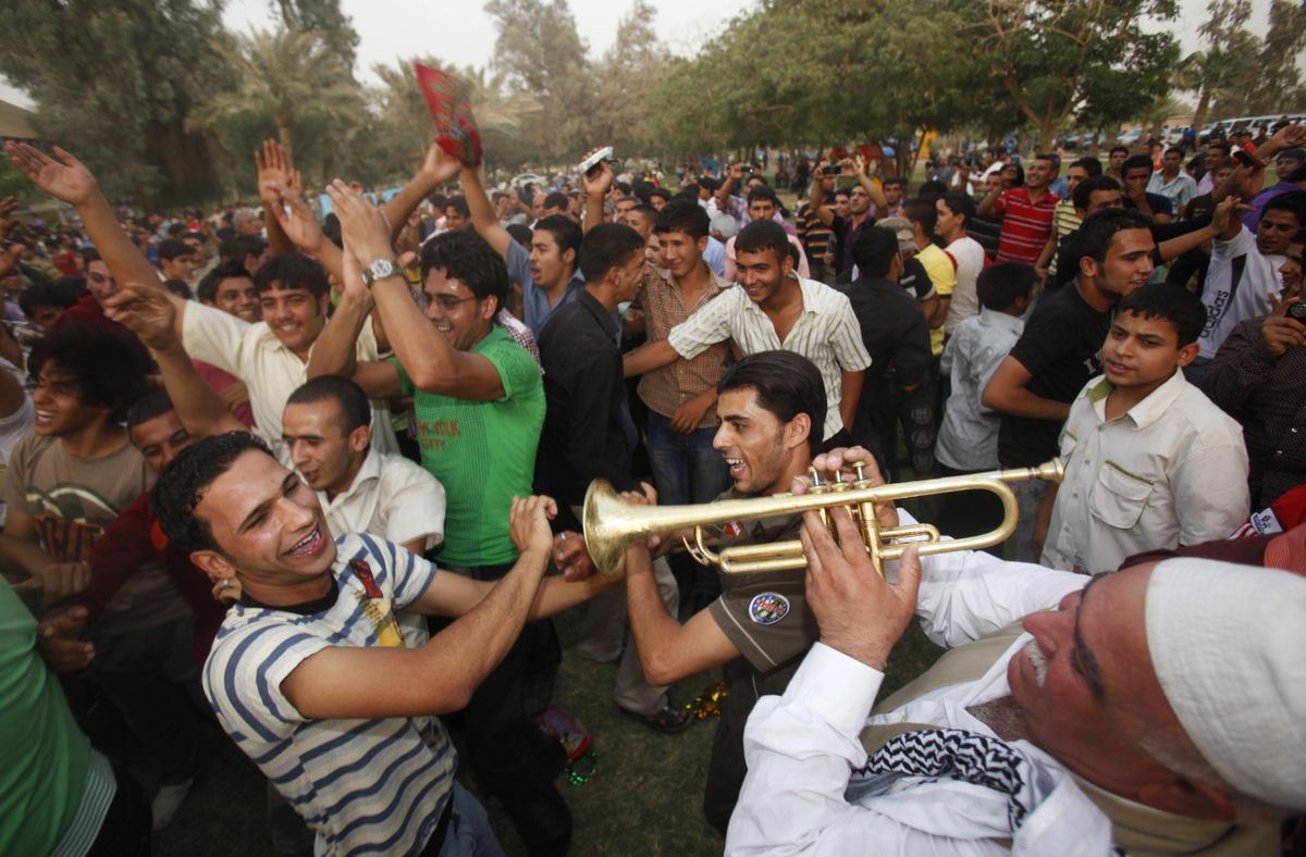 Iraqis celebrate in Baghdad, Iraq, on Monday as the midnight deadline approaches for U.S. troops to leave Iraqi cities –  the first step toward winding down the American war effort.Associated Press photos (Associated Press photos / The Spokesman-Review)