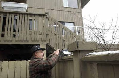 
Dave Morelli sets a live trap for squirrels at a Hayden home. Morelli traps nuisance animals ranging from mice to coyotes.
 (Brian Plonka / The Spokesman-Review)