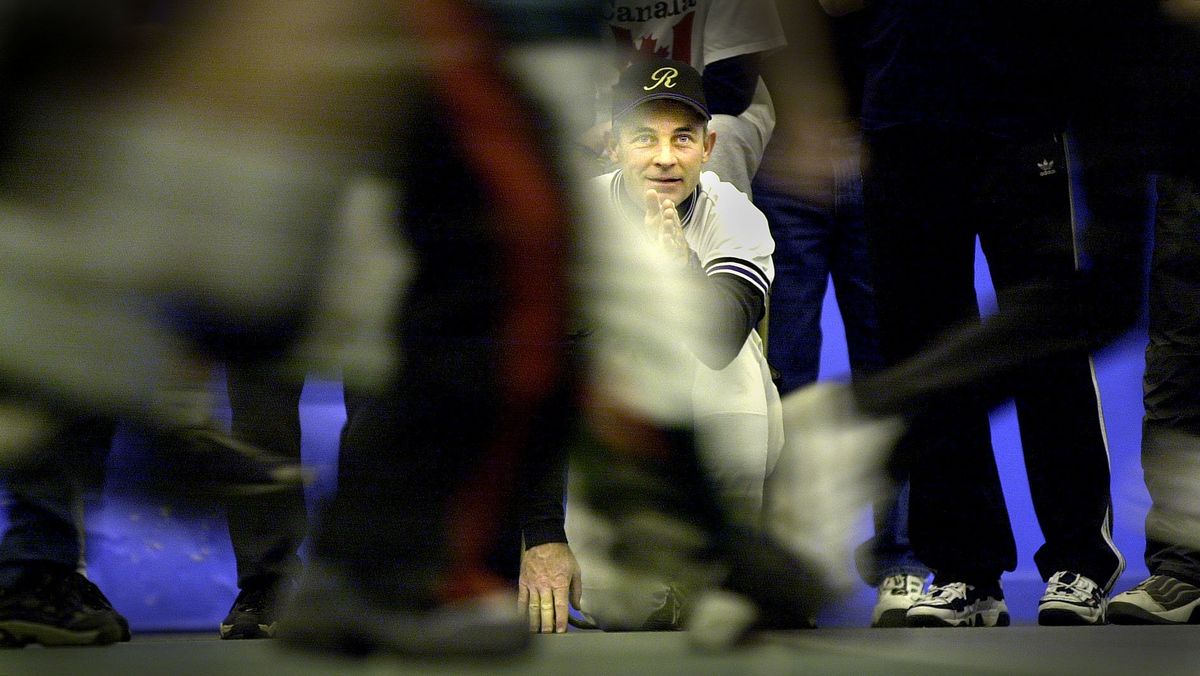 Rogers High School baseball coach Jim Wasem eyeballs the finish line of young baseball campers competing in the 20 yard sprints ,Saturday, at EWU closing out a 4 day Holiday Baseball Camp for area youngsters. Photo by Brian Plonka/The Spokesman-Review  (Brian Plonka)