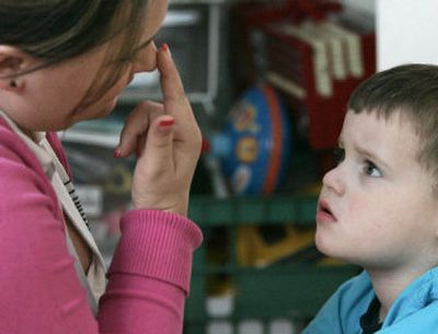 
Instructional assistant Jessica Reeder touches her nose to get Jacob Day, 3, who is autistic, to focus  on her during therapy at the Day home in Antelope, Calif., in  April. 
 (Associated Press / The Spokesman-Review)