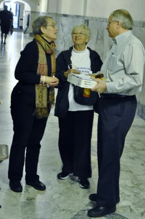 OLYMPIA -- House Speaker Frank Chopp buys cookies and a brownie from Kate Hunter, left, and Maureen Bo at a bake sale n the Capitol Building by senior citizens who contend the state isn't spending enough on programs for seniors and the disabled. (Jim Camden)