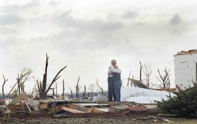 
Two unidentified residents console one another amid the flattened rubble of their home Tuesday in Madisonville, Ky.  
 (Associated Press / The Spokesman-Review)