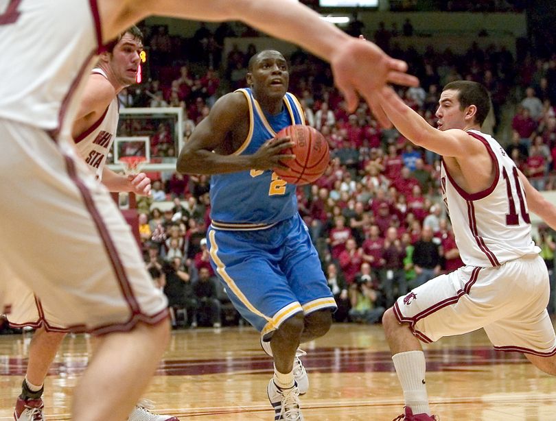 UCLA guard Darren Collison drives to the basket as Washington State's Aron Baynes , Caleb Forrest, center, and Taylor Rochestie. (Dean Hare / Associated Press)