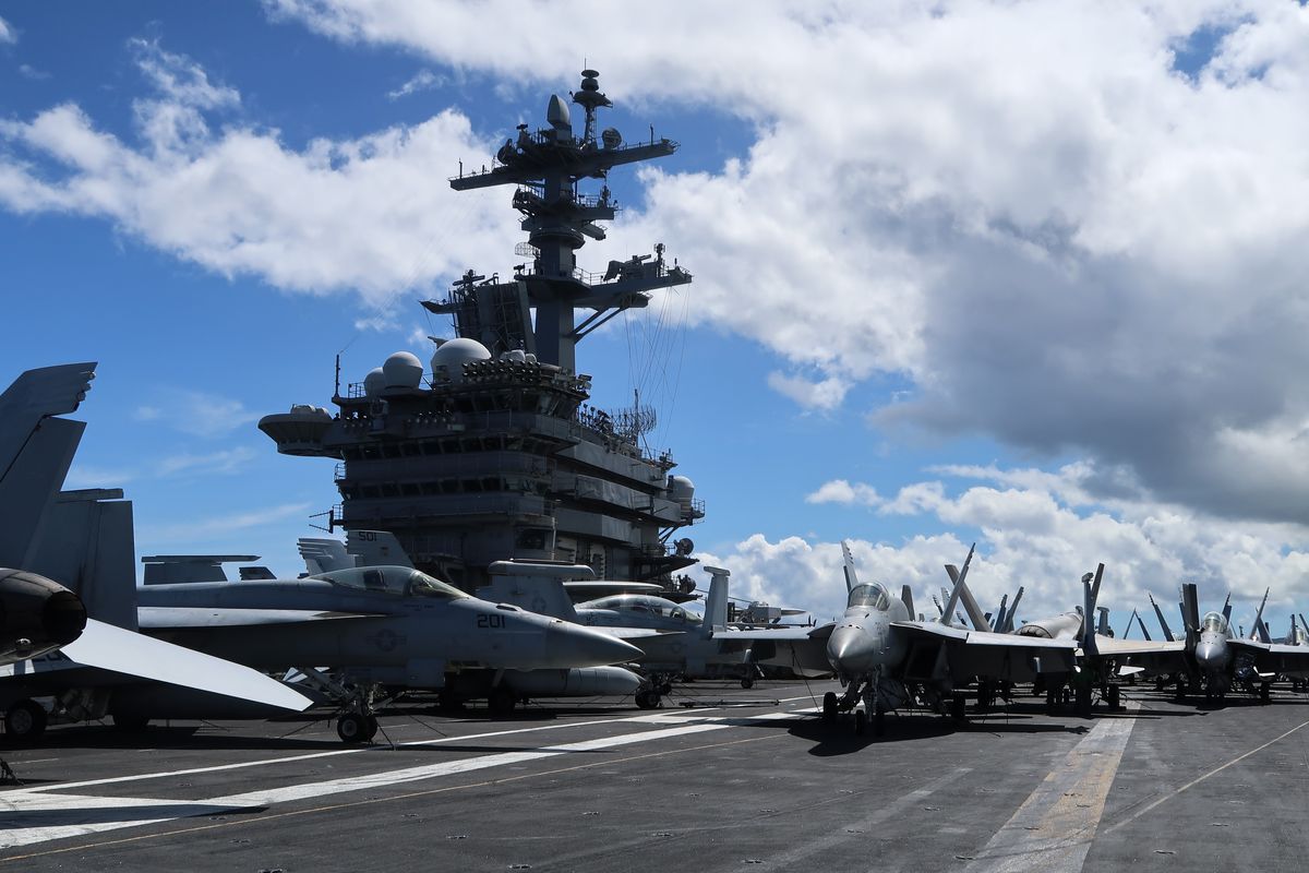 F-18 and F-35 fighter jets on the deck of the USS Abraham Lincoln.   (Bloomberg)