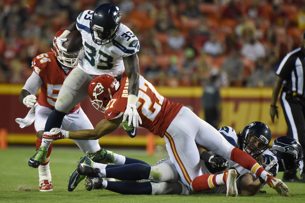 Seahawks running back Christine Michael (33) is tackled by Chiefs defensive back Tyvon Branch. Michael had just 27 yards on 10 carries. (Associated Press)