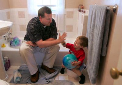 
Steve Harmon and his son, Nathan, 2, celebrate after Nathan goes to the potty at their Akron, Ohio, home.
 (Knight-Ridder / The Spokesman-Review)