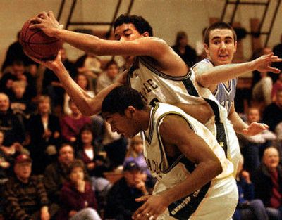 
Shadle Park's Anthony Brown pulls a rebound over teammate Anthony Fountain and Central Valley defender Chris Burdick, right. Shadle Park won 67-48.
 (Brian Plonka / The Spokesman-Review)