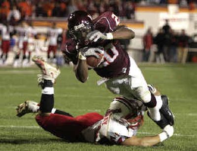 
Virginia Tech tailback Mike Imoh scores one of his two touchdowns during the Hokies' 55-6 rout of Maryland. 
 (Associated Press / The Spokesman-Review)