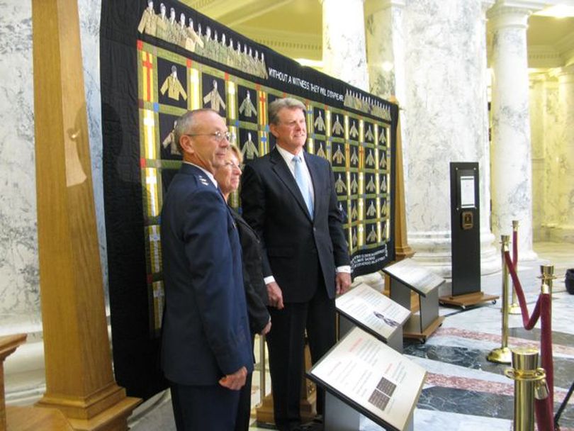 Paula Hylinski, center, mother of Cpl. Carrie French, an Idaho National Guard member who was killed in Iraq in 2005, joins National Guard Adjutant General Gary Sayler, left, and Idaho Gov. Butch Otter, right, to welcome the 