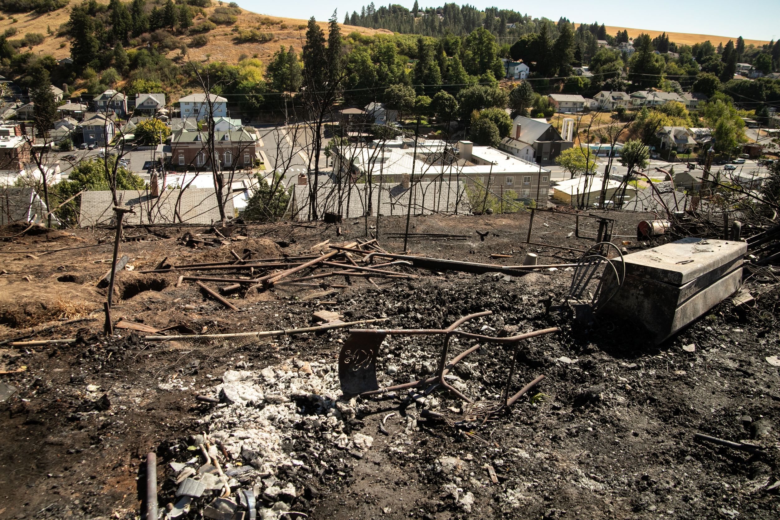 People clean up in Colfax after the fire Sept. 8, 2020 The