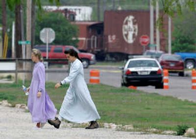 
Members of the Fundamentalist Church of Jesus Christ of Latter Day Saints walk toward their temporary housing at the Fort Concho complex in San Angelo, Texas, on Wednesday. Associated Press
 (Associated Press / The Spokesman-Review)