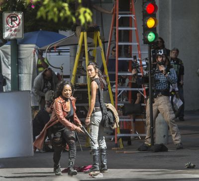 Z Nation actors Kellita Smith, as Warren, left, and Sydney Viengluang, as Sun Mei, shoot a scene on Wall Street, Aug. 26, 2016, in downtown Spokane. (Dan Pelle / The Spokesman-Review)