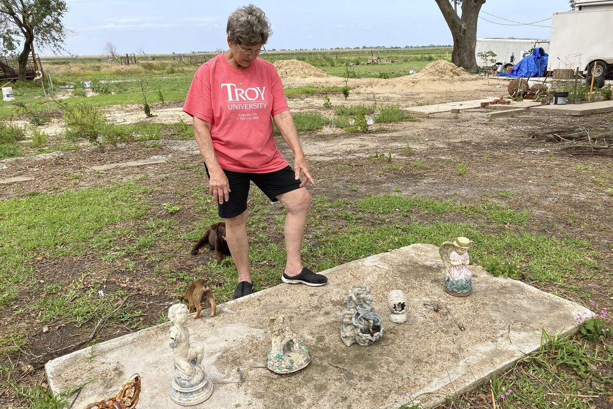 On Saturday, May 22, 2021, Grand Chenier, La., resident Margaret Little looks at some decorations and objects that had been around her home and that she recovered after Hurricane Laura destroyed her home last year.  (Rebecca Santana)