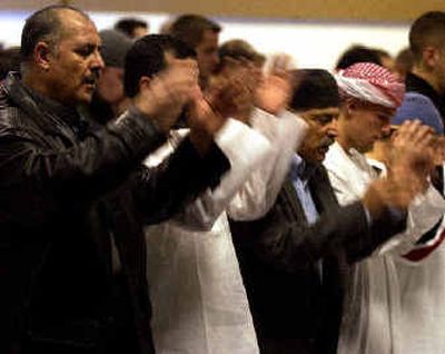 
Men offer Eid prayers Sunday at  Providence Auditorium at Sacred Heart Medical Center. 
 (Liz Kishimoto / The Spokesman-Review)