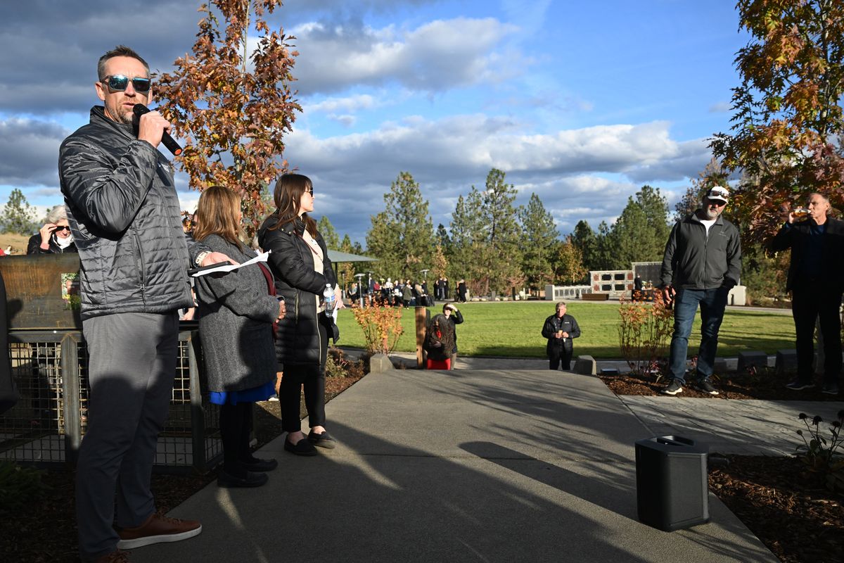 Dave Ittner, left, CEO of Fairmount Memorial Association, speaks Thursday during the opening of Timber Run Reserve, a new cemetery space designated for the cremated remains of people and their pets to be interred together at 822 N. Government Way in Spokane.  (Jesse Tinsley/THE SPOKESMAN-REVI)