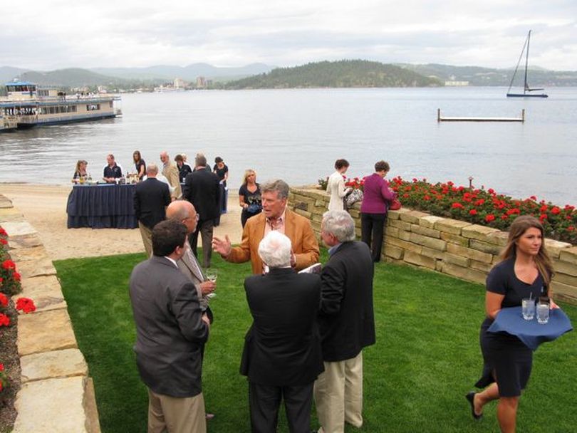 Idaho Gov. Butch Otter, center, visits with guests at the Western Governors Association's Wednesday night reception at the Casco Bay lake home of Coeur d'Alene resort owner Duane Hagadone. (Betsy Russell)