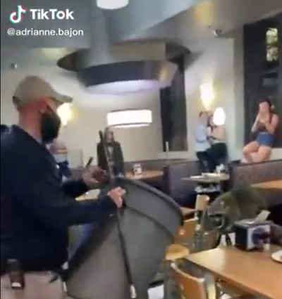 Screen capture of TikTok video taken by user @adrianne.bajon of university employees trying to corral a raccoon in the 459 Dining Hall on the Louisiana State University campus. 