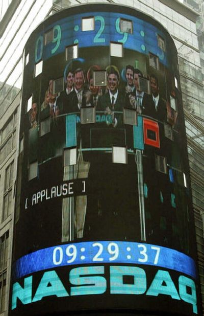The faces of Google and Nasdaq executives appear in a video image blown up on the giant wrap-around screen above the NASDAQ Marketsite as the company went public on Aug. 19, 2004. Money raised from going public has vastly increased Google's potential for expansion.
(Associated Press / The Spokesman-Review)