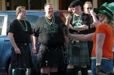 
Mike Johnson, Andy Williams, Blair Barney and Robert Barrett wear kilts as they watch last year's St. Patrick's Day parade along Sherman Ave. in Coeur d'Alene. 
 (File / The Spokesman-Review)