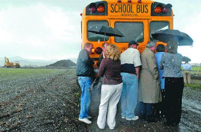 
Post Falls city and school officials take cover as a severe hail storm interrupts the groundbreaking ceremony for the new West Ridge Elementary  in Post Falls on Tuesday. The school will sit near the Kimbell International furniture plant and the Montrose subdivision, just off Seltice Way. 
 (Jesse Tinsley / The Spokesman-Review)