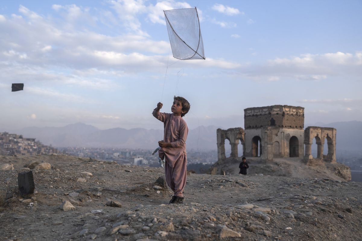 A boy flies a kite on Tape Nadir Khan hill in Kabul, Afghanistan, on Saturday, Dec. 4 , 2021.  (Petros Giannakouris)