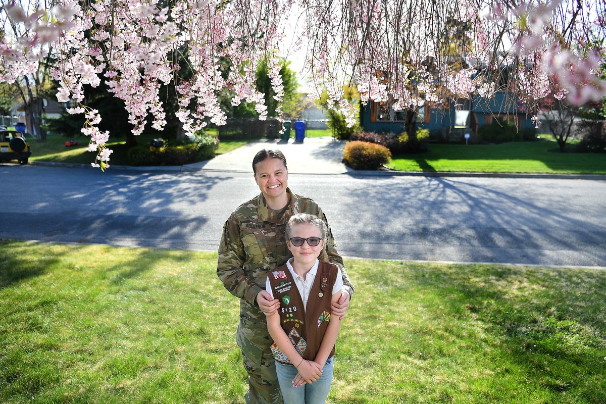 Girl Scout Paige Adolfson, 8, stands for a photo with her mother, Virginia Adolfson, on Wednesday at their home in Otis Orchards. PEMCO Mutual Insurance teamed with the Girl Scouts of Eastern Washington and Northern Idaho in recent, virtually taught sessions for second- through fifth-grade troops about cybersecurity and online safety. Paige completed the program.  (Tyler Tjomsland/The Spokesman-Review)