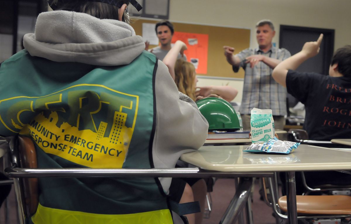 AmeriCorps volunteers Gabriel Brown (rear left) and Bill Skaer quiz Garry Middle School students about disaster preparedness April 23. AmeriCorps volunteers have been teaching disaster preparedness and first aid in Spokane middle schools all year. (Photos by CHRISTOPHER ANDERSON / The Spokesman-Review)