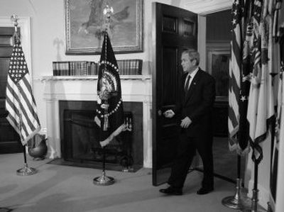 
President Bush enters the Roosevelt Room of the White House  to give a speech marking the fourth anniversary of the war in Iraq. 
 (Associated Press photos / The Spokesman-Review)