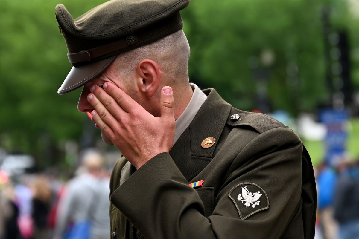Army National Guard Spec. Joseph Wolfe of Hagerstown, Md., wipes away tears after he saluted the hundreds of motorcyclists in the Rolling to Remember demonstration in May 2021 in Washington, D.C.  (Katherine Frey/The Washington Post)