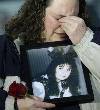 ORG XMIT: WATW106 Becky Washa, of Sioux Falls, South Dakota, cries as she holds a photo of her sister Holly Washa, Thursday, March 12, 2009, outside the Washington State Penitentiary in Walla Walla, Wash. The state Supreme Court stayed the execution of Cal Coburn Brown, who killed Holly Washa in 1991, on Thursday, just hours before he was to die in what would have been Washington state's first execution since 1991. (AP Photo/Ted S. Warren) (Ted Warren / The Spokesman-Review)