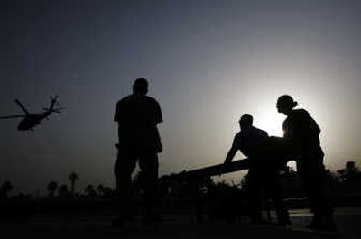 
U.S. Army nurses watch a helicopter carrying a patient take off from the helipad at Ibn Sina Hospital in the Green Zone in Baghdad on Friday. Associated Press
 (Associated Press / The Spokesman-Review)