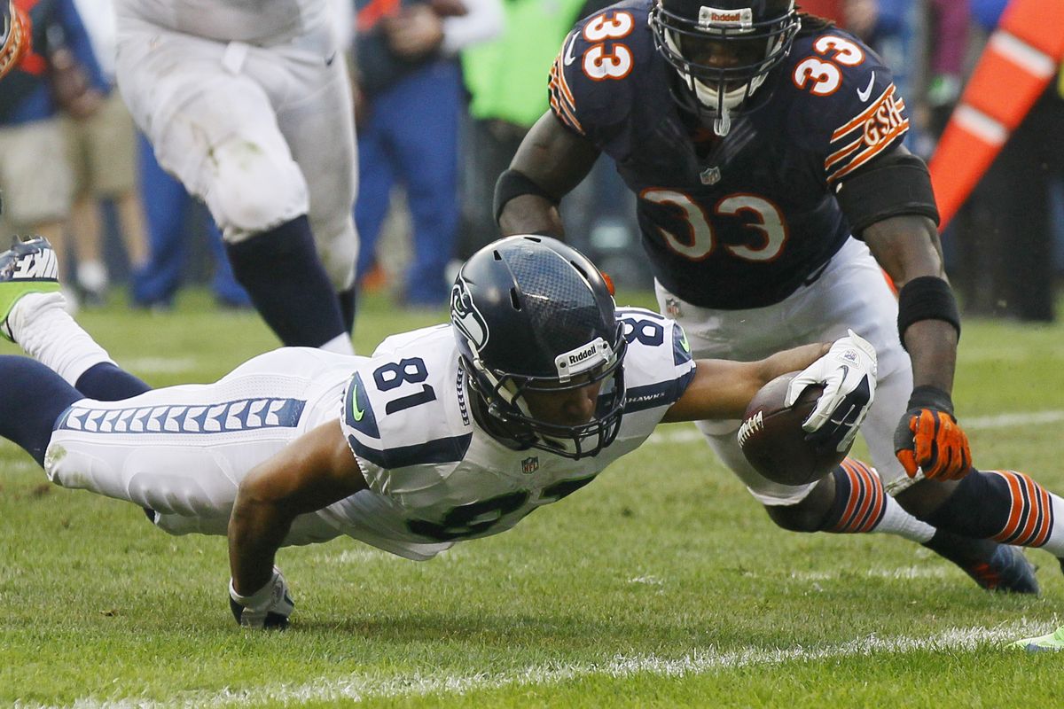 Seahawks wide receiver Golden Tate reaches successfully for the goal line as Bears cornerback Charles Tillman arrives too late. (Associated Press)