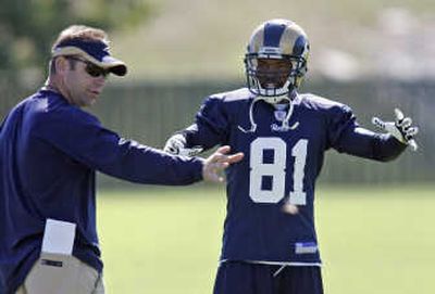 Associated Press St. Louis coach Scott Linehan, left, is trying to lead Torry Holt and the Rams to their first win when they visit Seattle today.
(Associated Press / The Spokesman-Review)