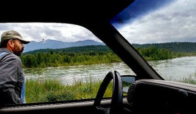 
Bonners Ferry farmer Bill Michalk  keeps an eye on the Kootenai River on Tuesday as it rises and erodes  his land. 
 (Photos by KATHY PLONKA / The Spokesman-Review)