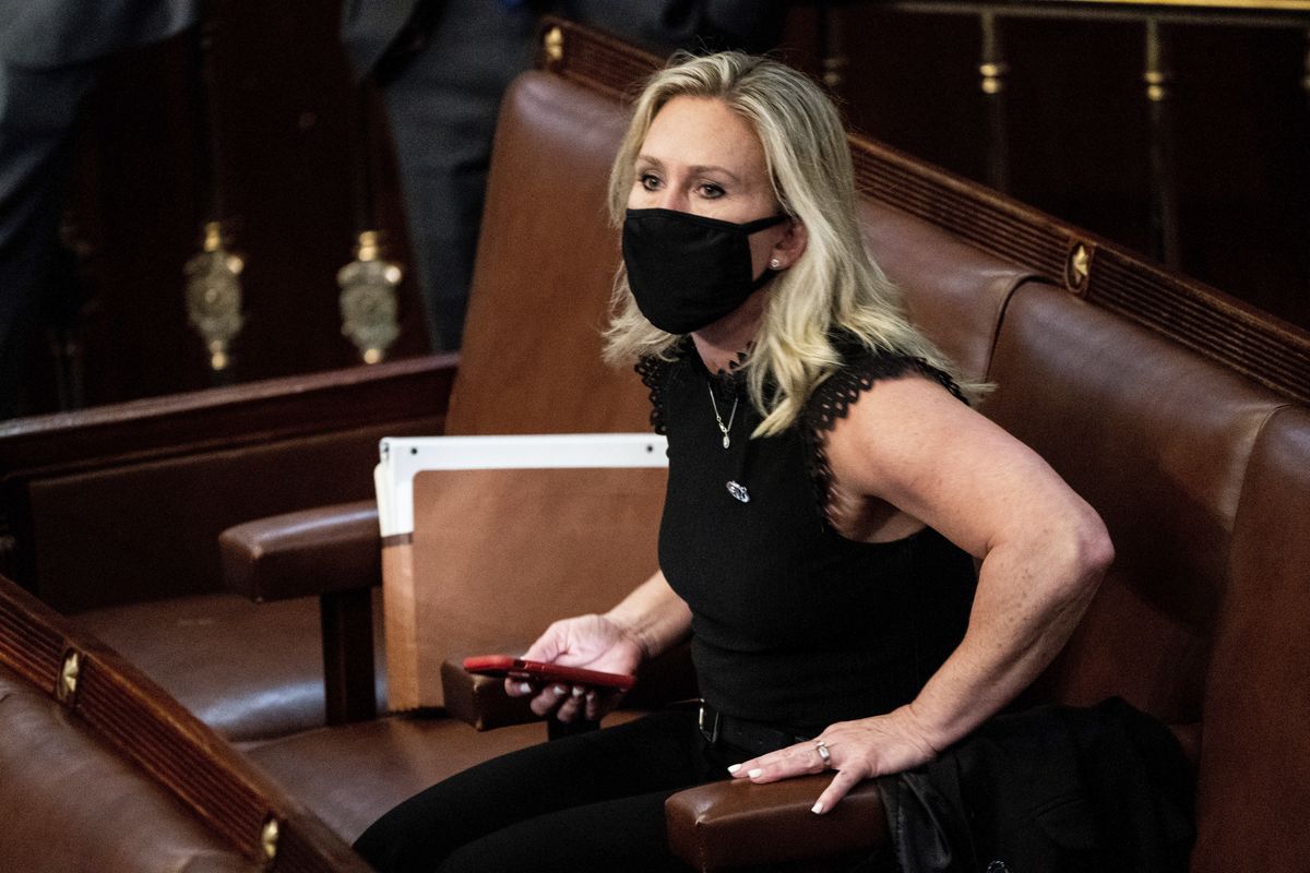 FILE - In this Jan. 6, 2021, file photo, Rep. Marjorie Taylor Greene, R-Ga., sits in the House Chamber after they reconvened for arguments over the objection of certifying Arizona