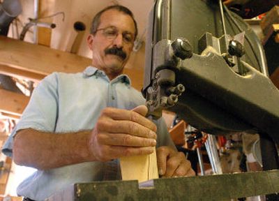 
Allen Dodge carefully cuts out shapes for folk art sculpture. He crafts the wood, and his wife, Mary Dee, paints them. The couple will be at Art on the Green this year. 
 (The Spokesman-Review)