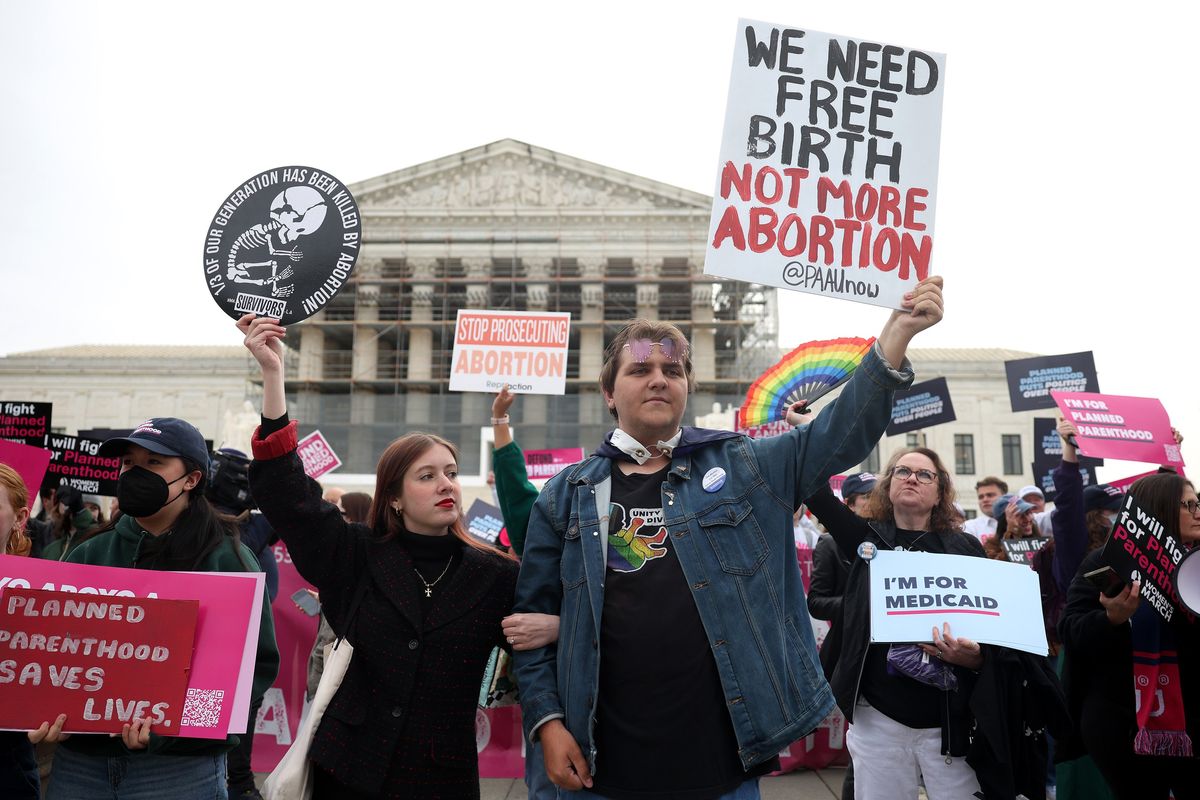 Anti-abortion protesters Kristin Turner, left, and Hayden Laye demonstrate outside the U.S. Supreme Court as oral arguments are delivered in the case of Medina v. Planned Parenthood South Atlantic on Wednesday in Washington, D.C. (Kayla Bartkowski/Getty Images North America/TNS)