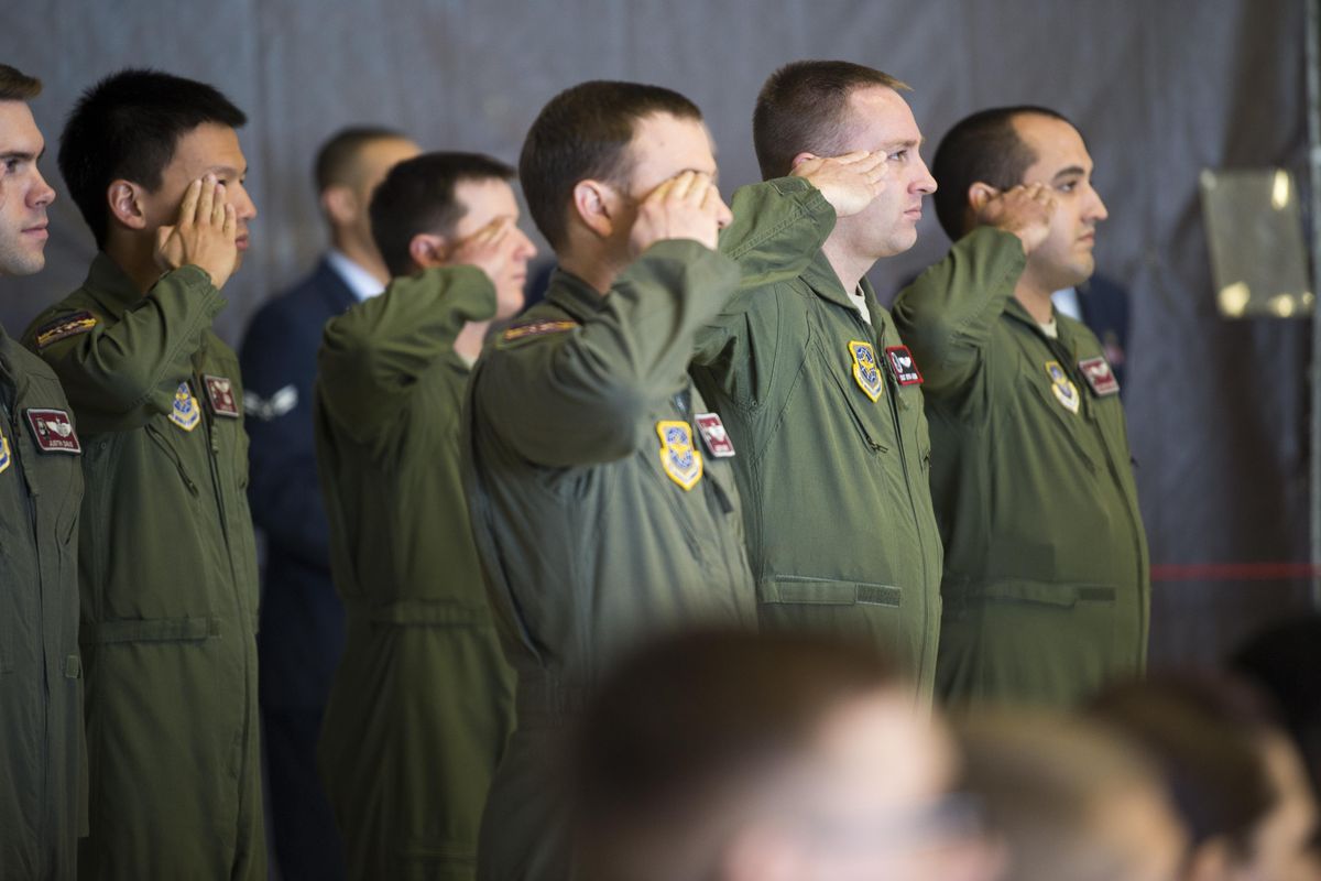 Members of the 384th Air Refueling Squadron salute during the ceremony to mark the joining of their squadron to the 92nd Air Refueling Wing at Fairchild Air Force Base on Thursday. (Jesse Tinsley / The Spokesman-Review)