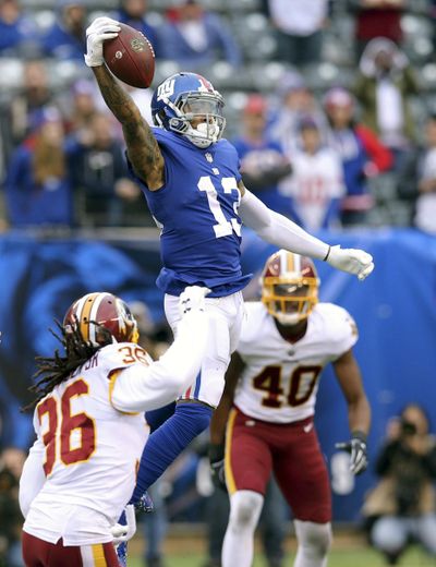 In this Oct. 28, 2018 photo, New York Giants wide receiver Odell Beckham Jr. (13) makes a one handed catch against Washington Redskins safety D.J. Swearinger (36) and linebacker Josh Harvey-Clemons (40) during an NFL football game, in East Rutherford, N.J. No longer a punching bag, the Browns are punching back. From hopeless to hopeful. Finally. In landing Beckham, one of the game’s most electrifying players, the Browns have risen from the deepest depths imaginable in just a year. (Brad Penner / Associated Press)