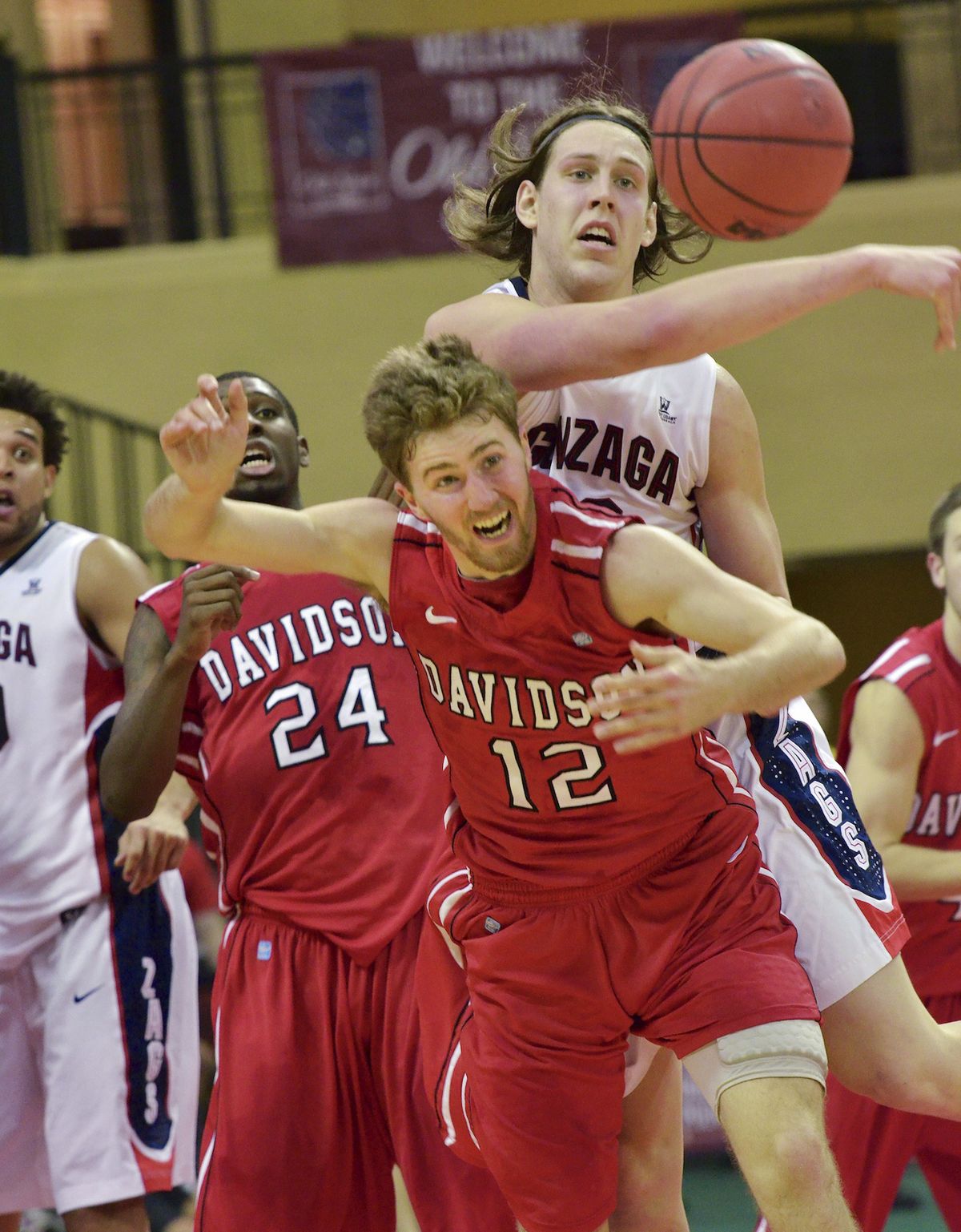 Gonzaga’s Kelly Olynyk goes for a loose ball against Davidson’s Nik Cochran (12) during the first half. (Associated Press)