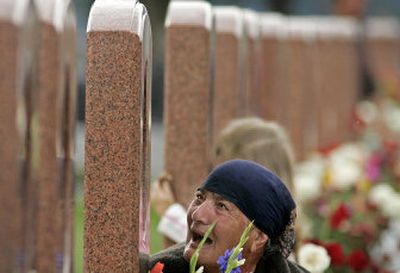 
A woman grieves at the cemetery in Beslan, Russia, Friday. More than 330 people were killed during a school seizure in Beslan one year ago. 
 (Associated Press / The Spokesman-Review)