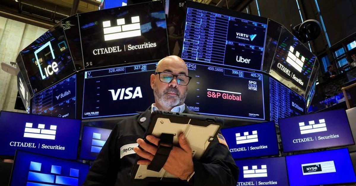 Dow jumps to record closing high after soft US jobs data, Nasdaq down with chip shares